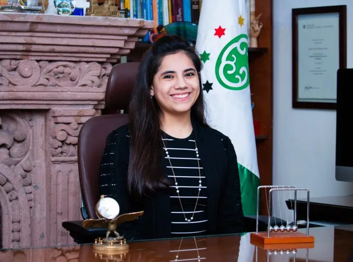Young girl, black hair, black dress, sitting