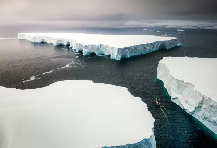 Sailing through enormously huge icebergs near Melchior islands in Antarctica