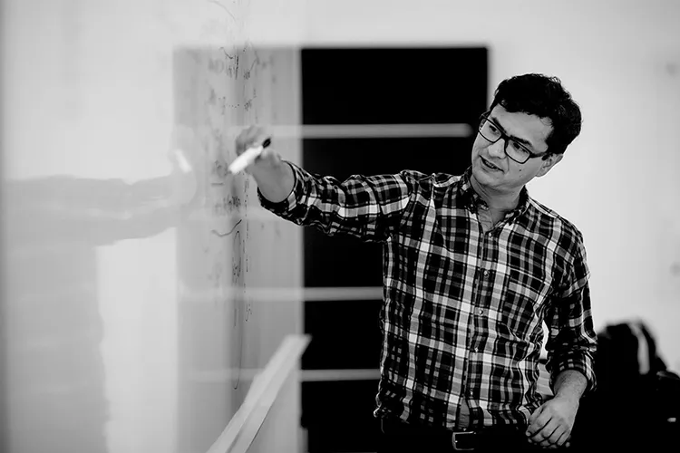 man leaning on a railing looking at the horizon