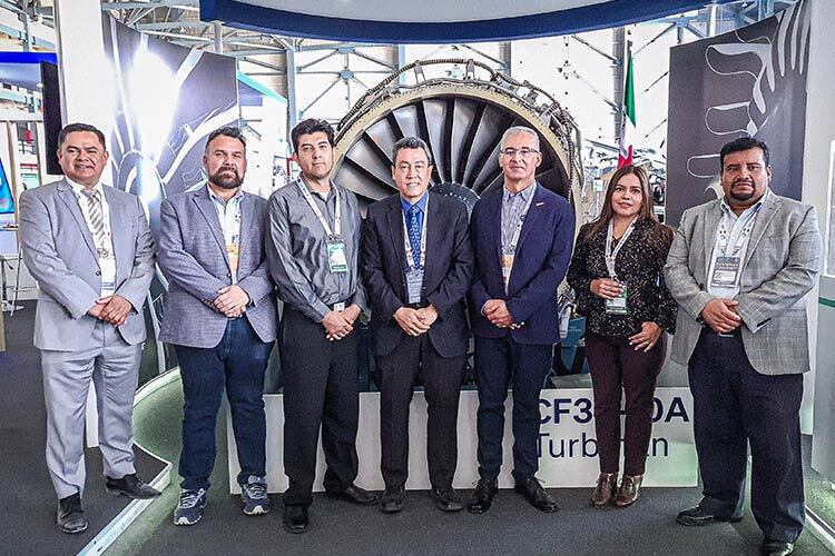 Four men and one woman at the FAMEX 2023 aerospace fair

