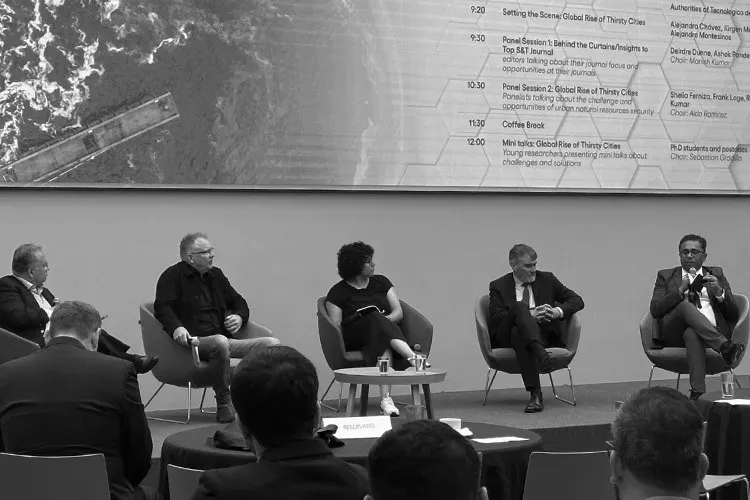 Five people sit in a panel and discuss important topics