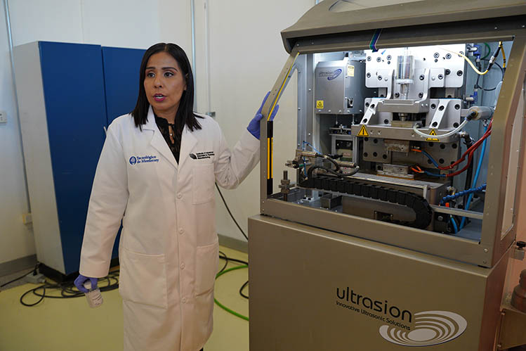photo of a researcher next to an ultrasonic machine