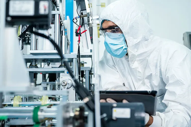 image of a man in a dressing gown in front of a machine