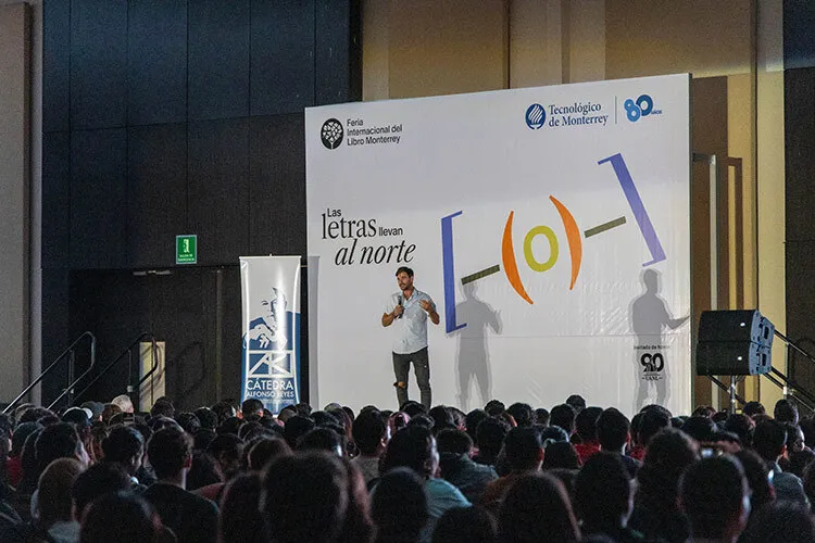 Man giving a speech in a big auditorium