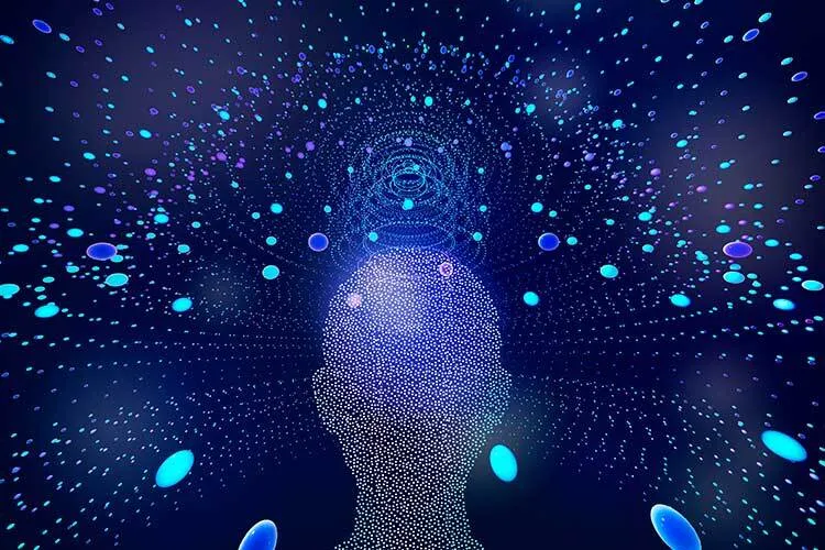 Image of a person's head made up of dots surrounded by blue dots on a blue background. The image is a digital illustration of a person's head. The head is made up of many small dots, which are arranged in a way that suggests the shape of a human head. The head is surrounded by a field of blue dots, which are also arranged in a circular pattern. The background of the image is a solid blue color.