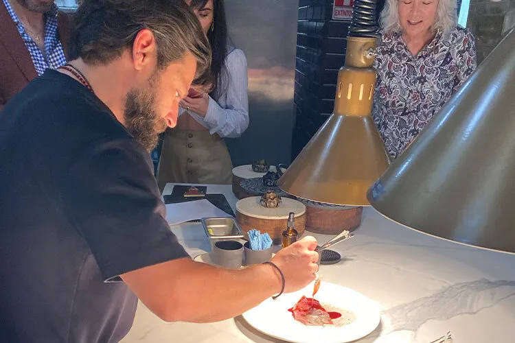 Chef adds last details to a Forma Foods dish with plant-based meat