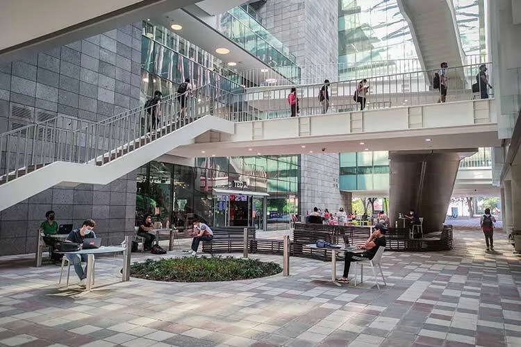 Here's a picture of the interior hallway of the library building at Tec de Monterrey, with students walking through corridors and ascending stairs.