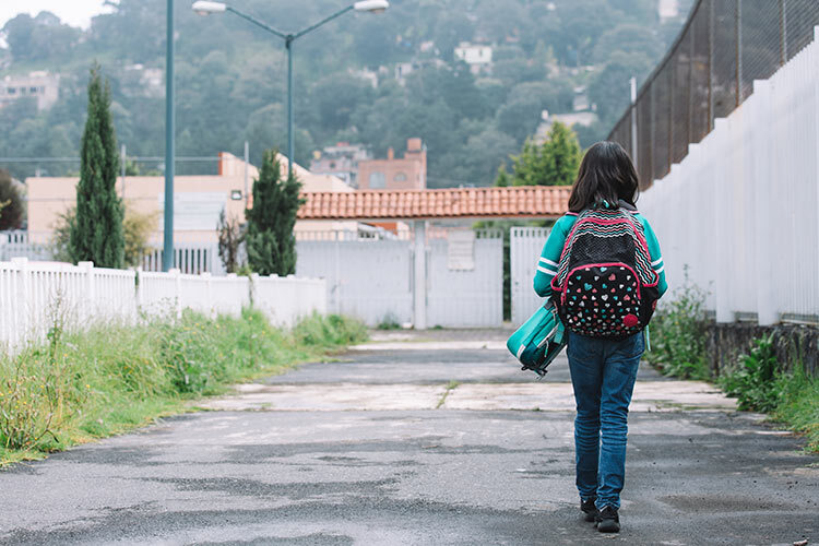 Photograph of a child walking on a street