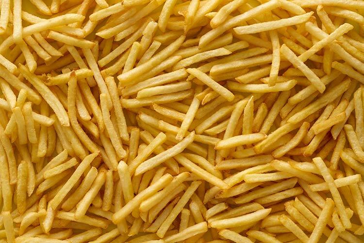 a photograph of hundreds of yellow french fries