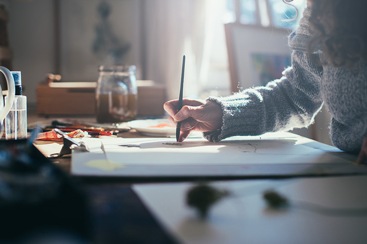 Photograph of a person writing in an office