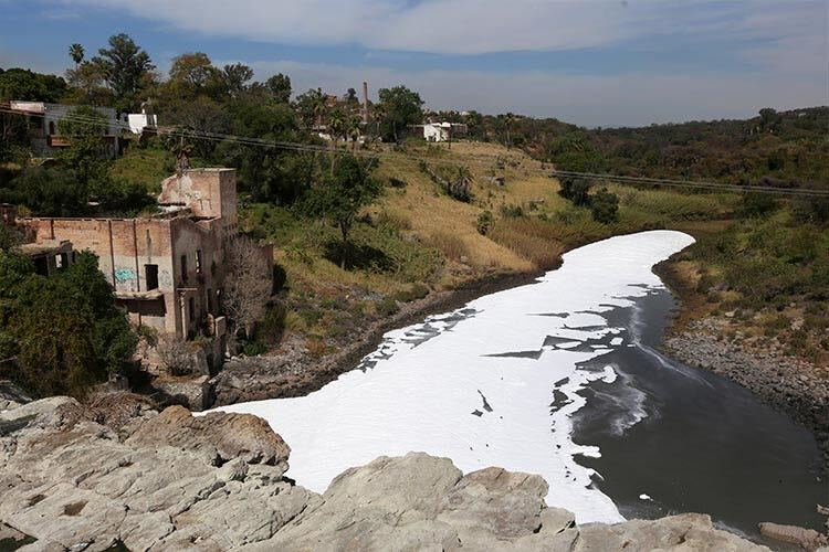 In the image, foam covers the Santiago River, whose contaminated waters have been linked to global manufacturers