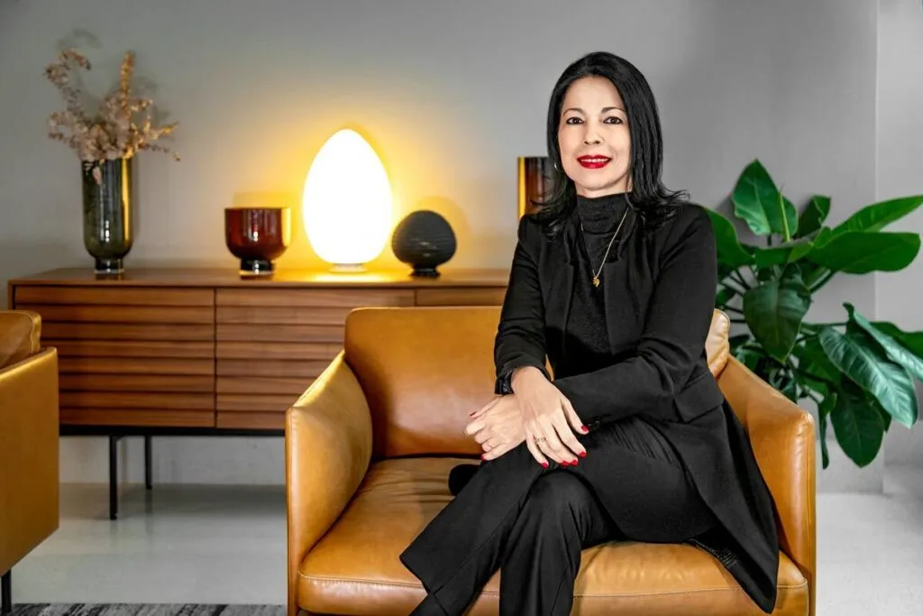 Woman with black suit in a cozy living room