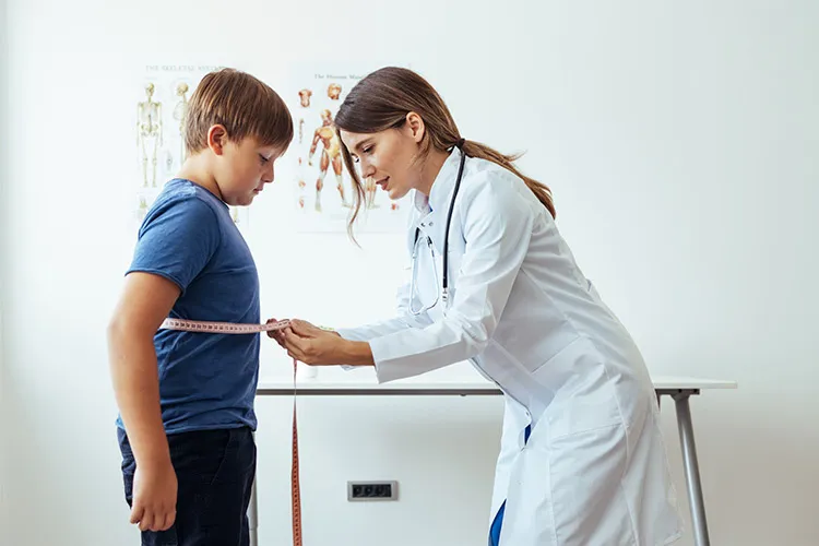image of a person with a tapemeter sizing a child waste