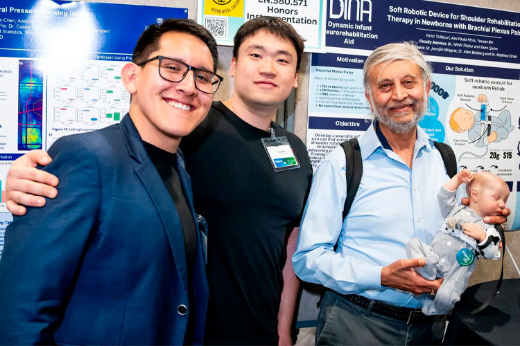 Members of the DINA team pose in front of their poster about the neonatal rehabilitation robot at the American Society of Mechanical Engineers 2025 Innovation Showcase.