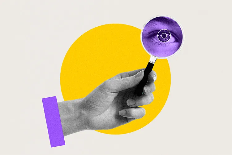 Image shows a hand holding a magnifying glass aimed at examining a close-up of an eye