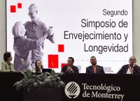 photograph of two women and three men sitting in a conference