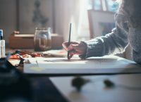 Photograph of a person writing in an office