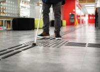 Photograph of a person using a cane for the blind