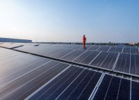 Solar panels installed on an industrial metal roof help generate energy and reduce indoor heat.