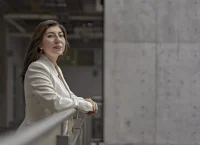 Woman standing leaning on a railing