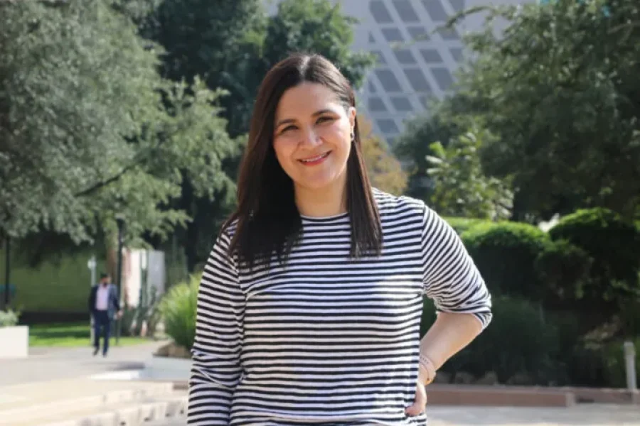 Middle-aged woman, long black hair, and white and black sweater