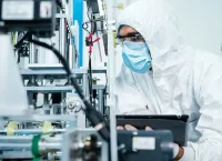 image of a man in a dressing gown in front of a machine