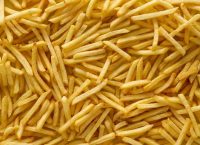 a photograph of hundreds of yellow french fries