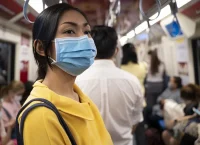 Masked girl to protect herself from Covid 19 virus in public area