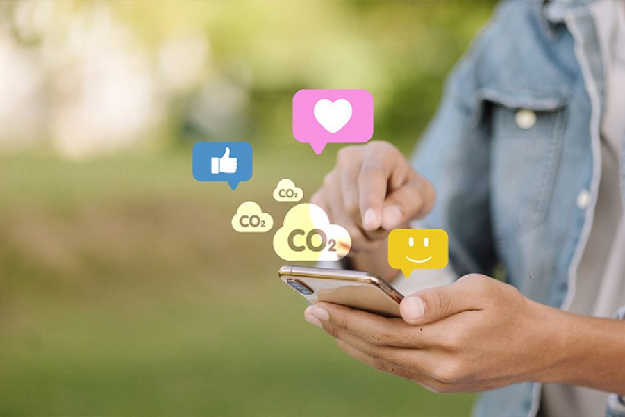A mobile phone user is shown touching the screen, from which heart icons and clouds labeled “CO₂” appear.