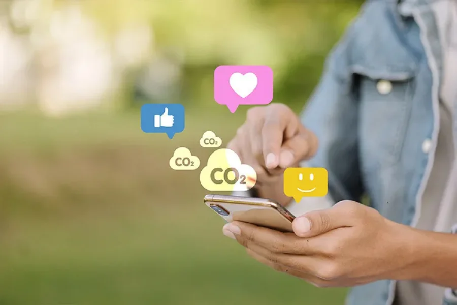 A mobile phone user is shown touching the screen, from which heart icons and clouds labeled “CO₂” appear.