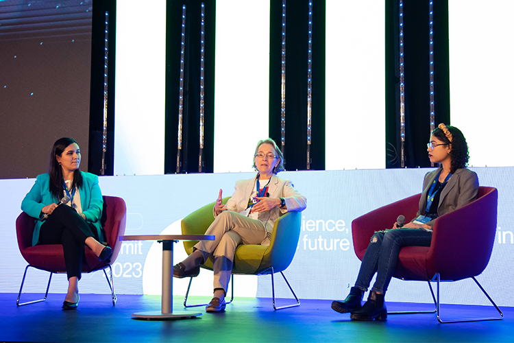 tres mujeres sentadas en una conferencia